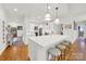 Bright, modern kitchen with white cabinetry, a large island with seating, and stainless steel appliances at 908 Gardenia St, Fort Mill, SC 29708