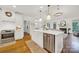 Open kitchen with a center island, stainless steel appliances, and seamless flow to the living area at 908 Gardenia St, Fort Mill, SC 29708