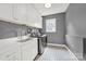 Well-organized laundry room with white cabinets, sink, and modern washer and dryer at 908 Gardenia St, Fort Mill, SC 29708