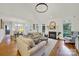 Open-concept living room with vaulted ceilings, fireplace, and views into the dining area at 908 Gardenia St, Fort Mill, SC 29708