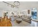 Bright living room featuring soaring ceilings, natural light, hardwood floors, and an open floor plan at 908 Gardenia St, Fort Mill, SC 29708