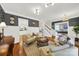 Spacious living room with hardwood floors, designer paint, and views of the office and staircase at 908 Gardenia St, Fort Mill, SC 29708