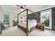 Bright main bedroom with four-poster bed, tray ceiling, and lots of natural light at 908 Gardenia St, Fort Mill, SC 29708