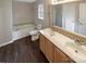Well-lit bathroom with double vanity, soaking tub, and modern fixtures for a spa-like experience at 9527 Scotland Hall Ct, Charlotte, NC 28277