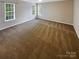 Neutral bedroom featuring carpet flooring, two large windows bringing in lots of natural light at 9527 Scotland Hall Ct, Charlotte, NC 28277