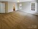 Neutral bedroom featuring carpet flooring, with ensuite bathroom, and two large windows bringing in lots of light at 9527 Scotland Hall Ct, Charlotte, NC 28277
