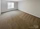 Neutral toned bedroom with natural lighting, offers comfortable space for relaxation and personalization at 9527 Scotland Hall Ct, Charlotte, NC 28277