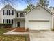 Charming two-story home featuring a two-car garage and classic curb appeal with meticulous landscaping in a suburban neighborhood at 9527 Scotland Hall Ct, Charlotte, NC 28277