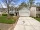 Traditional two-story home with a two car garage, nice lawn, and long concrete driveway at 9527 Scotland Hall Ct, Charlotte, NC 28277