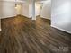 Open-concept living area with hardwood floors, ample space, and inviting light fixtures, perfect for gatherings at 9527 Scotland Hall Ct, Charlotte, NC 28277