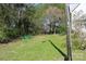 Level backyard bordered by trees and foliage, offering privacy and a connection with nature at 9915 Lottie Ln, Charlotte, NC 28262