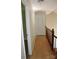 Well-lit hallway with hardwood floors and closet doors, offering a clean and modern look at 9915 Lottie Ln, Charlotte, NC 28262
