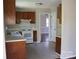 Functional kitchen features wooden cabinets, white appliances, and a neutral color scheme at 9915 Lottie Ln, Charlotte, NC 28262