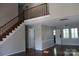 Bright and spacious living room featuring a staircase and gleaming hardwood floors at 9915 Lottie Ln, Charlotte, NC 28262