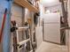 Unfinished basement with a ladder, shelves, drywall, and a vintage refrigerator at 1022 Kenilworth Nw Ct, Concord, NC 28027