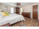 Comfortable bedroom with wooden floors, a ceiling fan, and access to an en-suite bathroom at 1022 Kenilworth Nw Ct, Concord, NC 28027