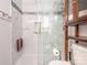 Modern shower with glass doors and grab bars, complemented by tiled walls with decorative accents at 1022 Kenilworth Nw Ct, Concord, NC 28027