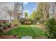 Well-manicured backyard featuring a wooden bench and mature landscaping at 107 Iris Meadow Dr, Mooresville, NC 28115