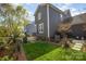 Well-maintained backyard with lush green grass, manicured landscaping, and mature trees offering ample shade at 107 Iris Meadow Dr, Mooresville, NC 28115
