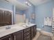 Bathroom featuring a double vanity with granite countertop and framed mirror at 107 Iris Meadow Dr, Mooresville, NC 28115