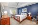 This bedroom features a tray ceiling, a blue accent wall and comfortable seating at 107 Iris Meadow Dr, Mooresville, NC 28115