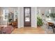 Inviting foyer with hardwood floors, natural light, and a view of the front yard through the glass front door at 107 Iris Meadow Dr, Mooresville, NC 28115