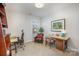 Bright office features multiple workstations, built-in shelving, and a comfortable chair at 107 Iris Meadow Dr, Mooresville, NC 28115