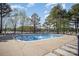 Inviting community pool surrounded by lounge chairs, mature trees, and clear blue water for relaxation and enjoyment at 107 Iris Meadow Dr, Mooresville, NC 28115