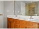Bathroom with double sinks, walk-in shower, and warm wood cabinets at 125 Snead Rd # 60, Fort Mill, SC 29715