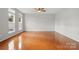 A spacious bedroom boasts gleaming hardwood floors and ample sunlight from several windows at 125 Snead Rd # 60, Fort Mill, SC 29715