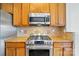 The kitchen has stainless steel oven and microwave, tile backsplash, and wood cabinets at 125 Snead Rd # 60, Fort Mill, SC 29715