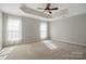 Spacious main bedroom with tray ceiling, fan, and bright, sun-filled windows at 125 Snead Rd # 60, Fort Mill, SC 29715