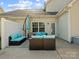 Back patio with comfortable seating, outdoor umbrella, and a cozy setting for outdoor relaxation at 13510 Brandon Trail Dr, Charlotte, NC 28213