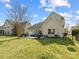 Large backyard with a patio area, providing ample space for relaxation and activities at 13510 Brandon Trail Dr, Charlotte, NC 28213