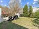 Backyard featuring a patio area, a dining set, and a shed, ideal for outdoor activities and storage at 13510 Brandon Trail Dr, Charlotte, NC 28213