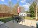 Backyard featuring a patio area, a dining set, and a shed, ideal for outdoor activities and storage at 13510 Brandon Trail Dr, Charlotte, NC 28213
