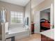 View of the bathroom from the tub showing the vanity and bedroom at 13510 Brandon Trail Dr, Charlotte, NC 28213