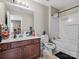 Functional bathroom featuring a wood vanity, large mirror, and a standard tub-shower combination at 13510 Brandon Trail Dr, Charlotte, NC 28213