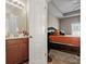 Bathroom vanity area leads into the main bedroom with tray ceiling and large bed at 13510 Brandon Trail Dr, Charlotte, NC 28213