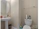 Half bathroom with sleek fixtures, pedestal sink, and modern design, perfect for guests at 13510 Brandon Trail Dr, Charlotte, NC 28213