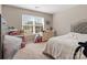 Bright bedroom with a large window, neutral carpet, and a comfortable bed with decorative headboard at 13510 Brandon Trail Dr, Charlotte, NC 28213