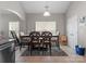 Bright dining room with a modern table, chairs, and a view into another room at 13510 Brandon Trail Dr, Charlotte, NC 28213
