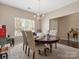 Bright dining area with classic round table and chairs, illuminated by natural light from a large window at 13510 Brandon Trail Dr, Charlotte, NC 28213