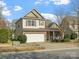 Two-story home featuring a two-car garage and landscaped front yard, showcasing curb appeal at 13510 Brandon Trail Dr, Charlotte, NC 28213