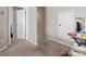 Hallway featuring neutral carpet and white doors, providing access to different areas of the home at 13510 Brandon Trail Dr, Charlotte, NC 28213