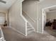 Hallway view leading to bedrooms, showcasing the home's layout and carpeted staircase at 13510 Brandon Trail Dr, Charlotte, NC 28213