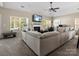 Comfortable living room featuring a fireplace, a large sectional sofa, and an adjacent workspace at 13510 Brandon Trail Dr, Charlotte, NC 28213