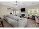 Bright living room with fireplace and windows, plus workspace and seamless transition to other rooms at 13510 Brandon Trail Dr, Charlotte, NC 28213