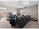 Spacious living room with a large sofa and an entertainment center with a flat screen TV at 13510 Brandon Trail Dr, Charlotte, NC 28213