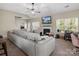 Spacious living room features a fireplace, large windows, and comfortable seating, perfect for relaxation at 13510 Brandon Trail Dr, Charlotte, NC 28213